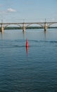 Floating red navigational buoy on blue water of Dnipro River. Royalty Free Stock Photo