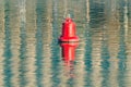 Floating red navigational buoy on water surface. Royalty Free Stock Photo
