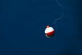 floating red and white fishing bobber