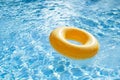 Floating ring on blue water swimpool with waves reflecting Royalty Free Stock Photo