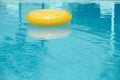 Floating ring on blue water swimpool with waves reflecting Royalty Free Stock Photo