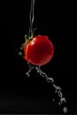 Floating ripe cherry tomatoes under runing water. Selective focus. Royalty Free Stock Photo