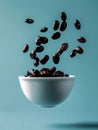 Floating Roasted Coffee Beans Spilling Over White Cup on Teal Blue Background Refreshing Morning Concept Royalty Free Stock Photo