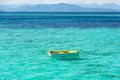 Floating Row Boat on Blue and Turquoise Clear Water Royalty Free Stock Photo