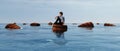 Floating sea. Man on wood barrel floating in the sea . Royalty Free Stock Photo