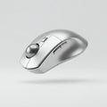 Floating silver ergonomic trackball mouse on a solid white background Royalty Free Stock Photo