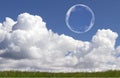 Floating Soap Bubbles Against Clear Sunlit Blue Sky and Clouds Royalty Free Stock Photo