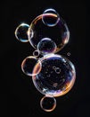 Floating Soap Bubbles Reflecting Light on Black Background Close Up Royalty Free Stock Photo