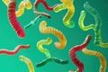 Floating sour gummy worms twisting on neon green Royalty Free Stock Photo