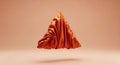 A floating, three-dimensional triangular shape draped in vibrant orange satin fabr Royalty Free Stock Photo