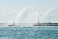 Tug boats spraying jets of water, demonstrating firefighting water cannons, fire boats spraying foam Royalty Free Stock Photo