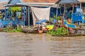 Floating village and a boy swimming in the Tonle Sap Lake in Ca Royalty Free Stock Photo