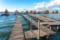 floating village bungalows in Bokod Hungary wit wooden pier walkway