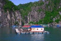 Floating village, rock island, Halong Bay, Vietnam Royalty Free Stock Photo