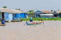 Floating village on the Tonle Sap Lake in Cambodia and kids row Royalty Free Stock Photo