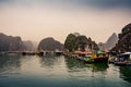 Floating village with wooden boats and fishing farms in the sea in between iconic karst lime stone rocks of Ha Long Bay. Lan Ha