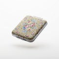 Floating vintage compact mirror with decorative cover on a solid white background Royalty Free Stock Photo