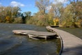 Floating walkway made of wooden planks. narrow curved paths on stilts driven into the bottom, above the lake water. has no railing Royalty Free Stock Photo