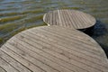 Floating walkway made of wooden planks. narrow curved paths on stilts driven into the bottom, above the lake water. has no railing Royalty Free Stock Photo