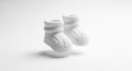 Floating White Knitted Baby Booties Against a Clean Light Background Royalty Free Stock Photo