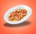 Floating White plate with baked shrimps and garlic