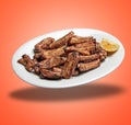 Floating White plate with Spare ribs and lemon Royalty Free Stock Photo