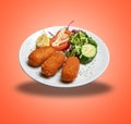 Floating White plate with three Shrimps croquettes ans salad Royalty Free Stock Photo