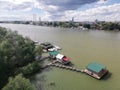 Floating wooden houses with boats on the river Sava in Belgrade, Serbia. View from the new Ada bridge. Royalty Free Stock Photo