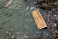 Floating wooden plank in lake water