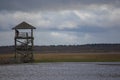 Floating wooden viewing tower on water.Latvia. Cloudy blue sky background Royalty Free Stock Photo