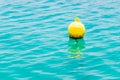 Floating yellow navigational buoy