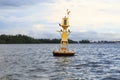 Floating yellow navigational buoy on blue sea