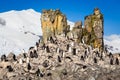 Flock of chinstrap penguins standing on the rocks with snow mountain in the background, Half Moon island, Antarctic peninsula Royalty Free Stock Photo