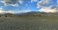 Flock of mountain goat and sheep grazing on a lawn in the mountains in autumn day. Panoramic view.