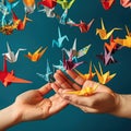 Flock of origami cranes out of hands