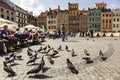 Flock of pigeons on famous Old Town Market square with colorful houses in Warsaw, Poland. June 2012 Rebuild Old town. Royalty Free Stock Photo