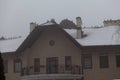 Flock of raven sits on roof of large house winter Royalty Free Stock Photo