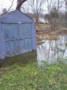 Flodded yard with a blue shed Royalty Free Stock Photo
