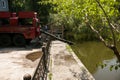 Flood in a city park after heavy rains. Fire truck with water pumping hoses eliminates the