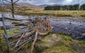 Flood debris and wood collected on a fence beside the water of Deugh river