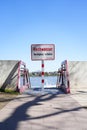 Flood high tide notice info sign on the sidewalk blocked, as a warning info board in German, German language Royalty Free Stock Photo