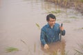 Flood water in ric field and pond, Farmer men working in nature water pond  of rice paddy field Royalty Free Stock Photo