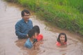 Flood water in rice field and pond, Farmer family working in nature water pond  of rice paddy field Royalty Free Stock Photo