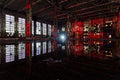 Flooded abandoned large industrial hall illuminated by red lights. Reflection in water. Abandoned Voronezh excavator plant Royalty Free Stock Photo