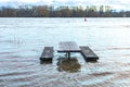 flooded bench at river Rhine in Eltville, Germany in sunset mood