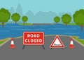 Flooded city road with warning sign and cones. British closed road sign. Royalty Free Stock Photo