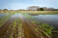Flooded dirt road and fields, April day Royalty Free Stock Photo