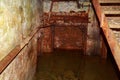 Flooded disguised secret military bunker. Abandoned bomb shelter