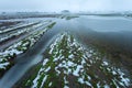 Flooded fields and dirt road after melting snow, january day in eastern Poland