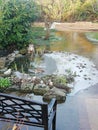 Flooded garden with ice surrounding pond with bench in foreground. Global Warming. Climatechange